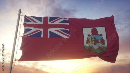 Flag of Bermuda waving in the wind, sky and sun background photo