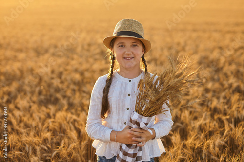 Happy girl walking in golden wheat  enjoying the life in the field.