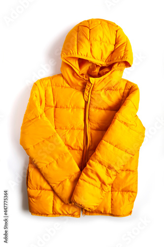 Warm yellow jacket on white background. Fashion outfit element. Bright colors. Home storage. Small space organizing.