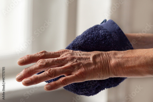 close-up of  a hand doing personal hygiene with a facecloth photo