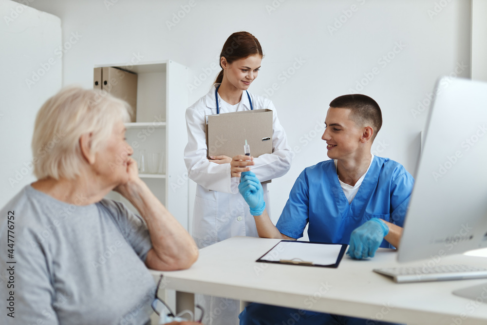 a nurse and a doctor examine a patient in a hospital a nurse and a doctor examine a patient in a hospital