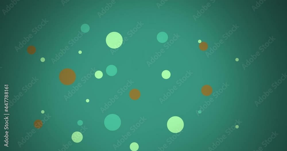 Animation of multi coloured dots moving over green background
