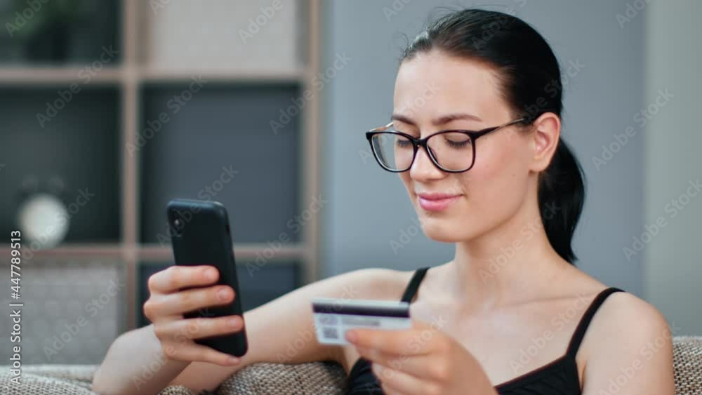 Happy Asian woman paying e money card enjoying online shopping use smartphone purchasing internet Happy Asian woman paying e money card enjoying online shopping use smartphone purchasing internet