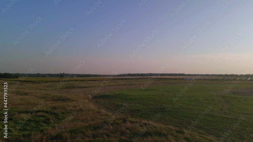 Small private airplane with propeller in front flying in blue sky at sunset. Private commercial flights by aircraft. Training pilots to drive, educational concept. Small private airplane with propeller in front flying in blue sky at sunset. Private commercial flights by aircraft. Training pilots to drive, educational concept.