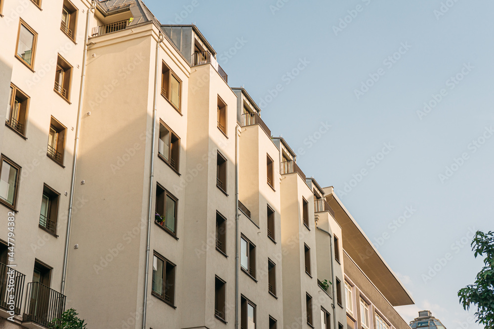 white apartment house with sunlight on the top white apartment house with sunlight on the top
