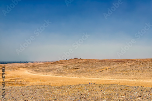 Desert landscape looking across a valley from one sand dune to another.