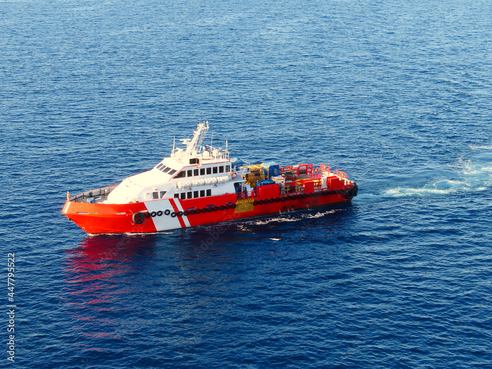 Supply boat transfer the cargo for supporting oil and gas industry and moving cargo from the boat to the platform. Boat is waiting transfer cargo and crews to platform. Supply boat transfer the cargo for supporting oil and gas industry and moving cargo from the boat to the platform. Boat is waiting transfer cargo and crews to platform.