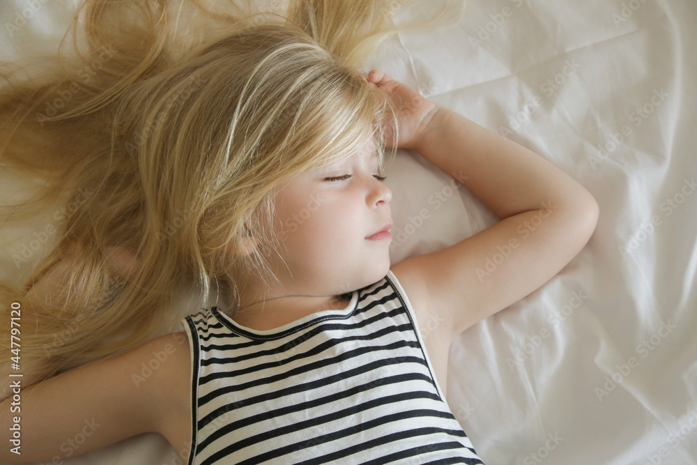 Sweet little girl sleeping in the bed, top view Sweet little girl sleeping in the bed, top view