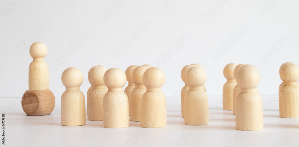 Wooden figure standing on the box for show influence and empowerment. Wooden figure standing on the box for show influence and empowerment.