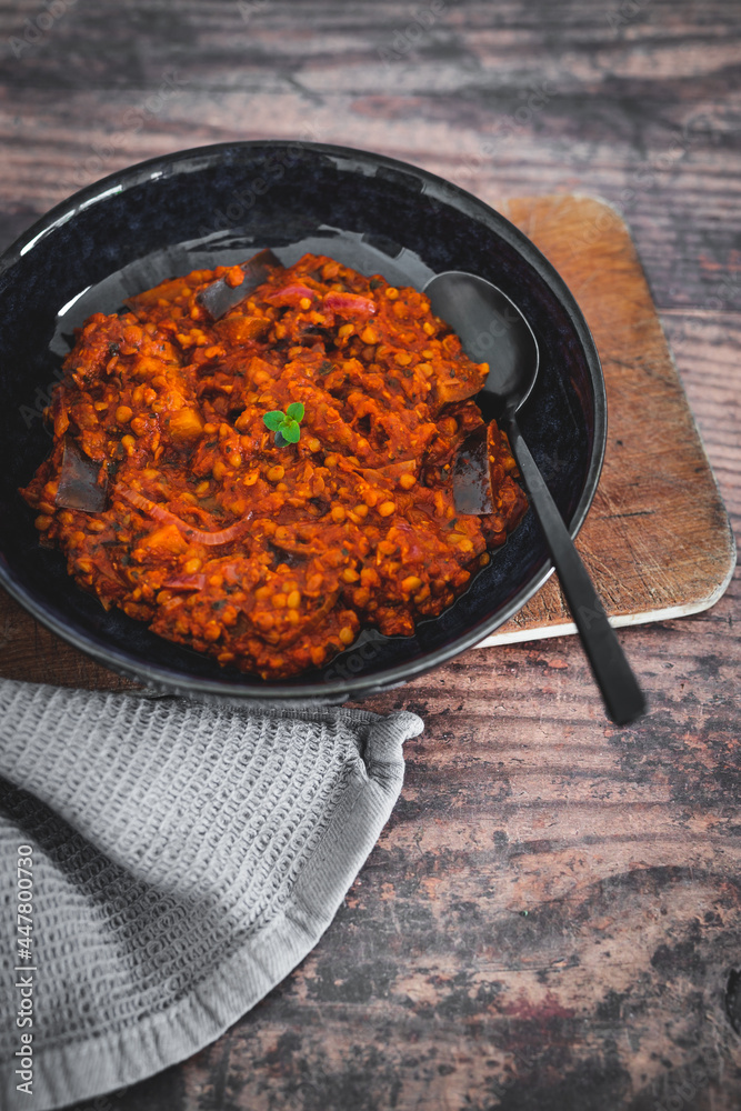 vegan vegan eggplant lentil curry with tomato sauce and cilantro, healthy plant-based food