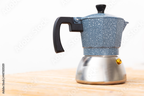 Coffee pot on wooden table in kitchen
