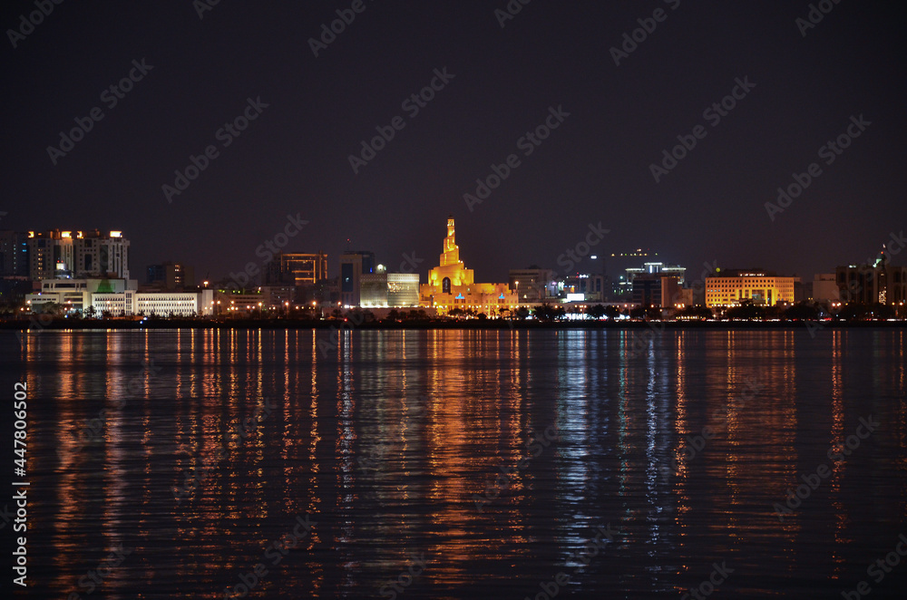 Night view of Doha corniche with lights reflecting in the water