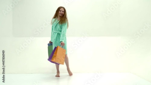 Little girl with multi-colored bags in their hands.