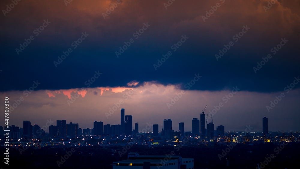 The high angle background of the city view with the secret light of the evening, blurring of night lights, showing the distribution of condominiums, dense homes in the capital community The high angle background of the city view with the secret light of the evening, blurring of night lights, showing the distribution of condominiums, dense homes in the capital community
