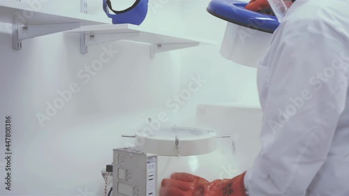 Technician Opening a Cryotank with Frozen Samples in Liquid Nitrogen at the Lab. Close Up. 4K Resolution. photo