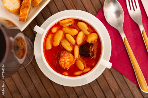 Fototapeta Naklejka Na Ścianę i Meble -  Traditional dish of Spanish cuisine is Fabada soup made of white Asturian beans with smoked pork knuckle and Choriso and ..Morcilla sausages