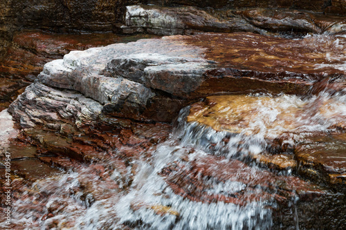 Water flowing over brown rocks
