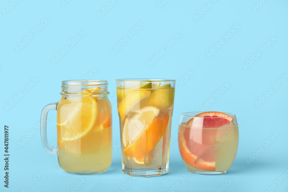 Glasses and mason jar of lemonade on color background Glasses and mason jar of lemonade on color background