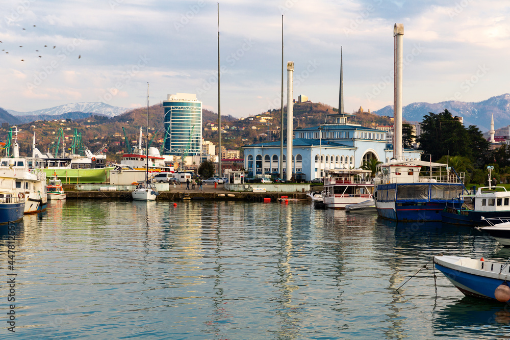 View from sea to Batumi Port with passenger station and boats moored near berths on spring day, Georgia