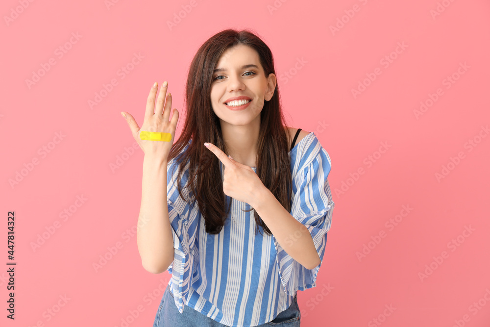 Young woman with applied medical patch against color background Young woman with applied medical patch against color background