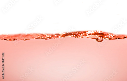 Clean orange water with water droplets and waves