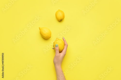 Female hand with lemons on ...