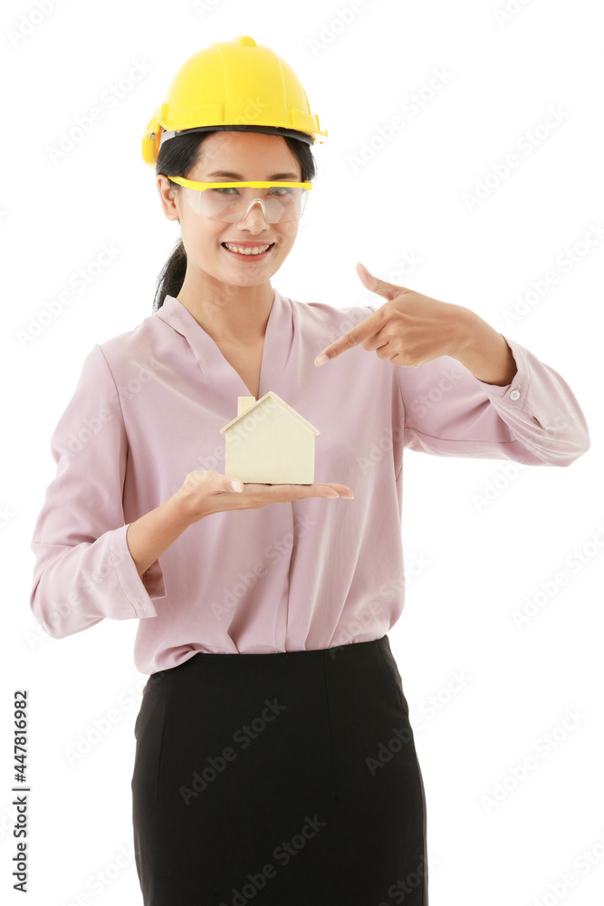 Portrait closeup isolated cutout shot of young smart Asian female construction engineer wears yellow safety hat and goggles stand smile hold design wooden concept home model in hand show thumb up Portrait closeup isolated cutout shot of young smart Asian female construction engineer wears yellow safety hat and goggles stand smile hold design wooden concept home model in hand show thumb up