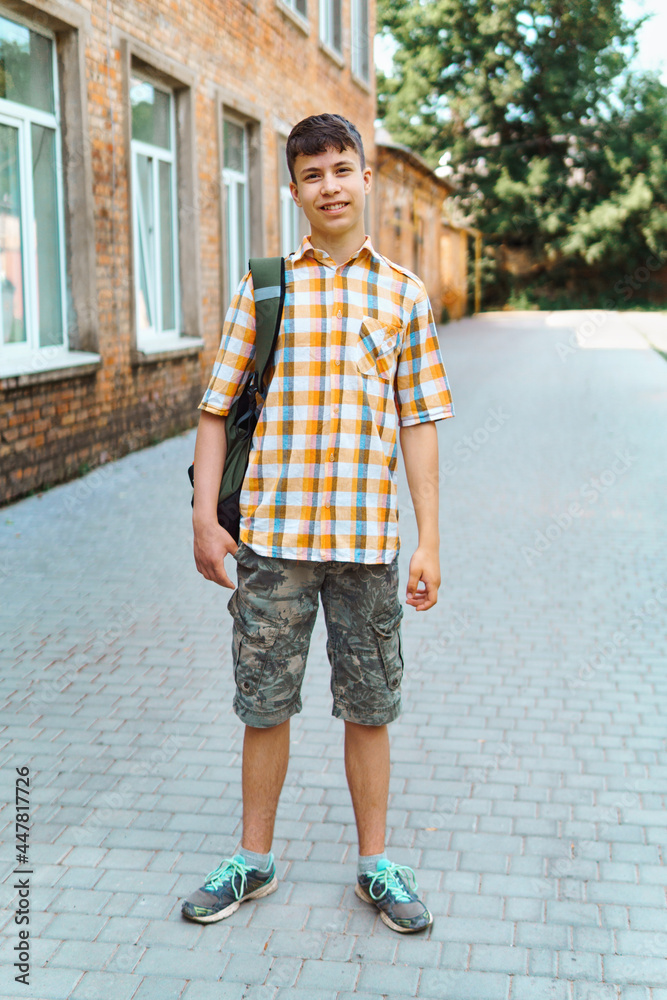 teen boy portrait on the way to school, education and back to school concept