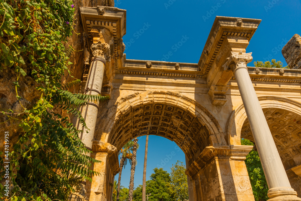 Fototapeta premium ANTALYA, TURKEY: Adrian Gate in the background blue sky. Antique ancient construction of marble and limestone.