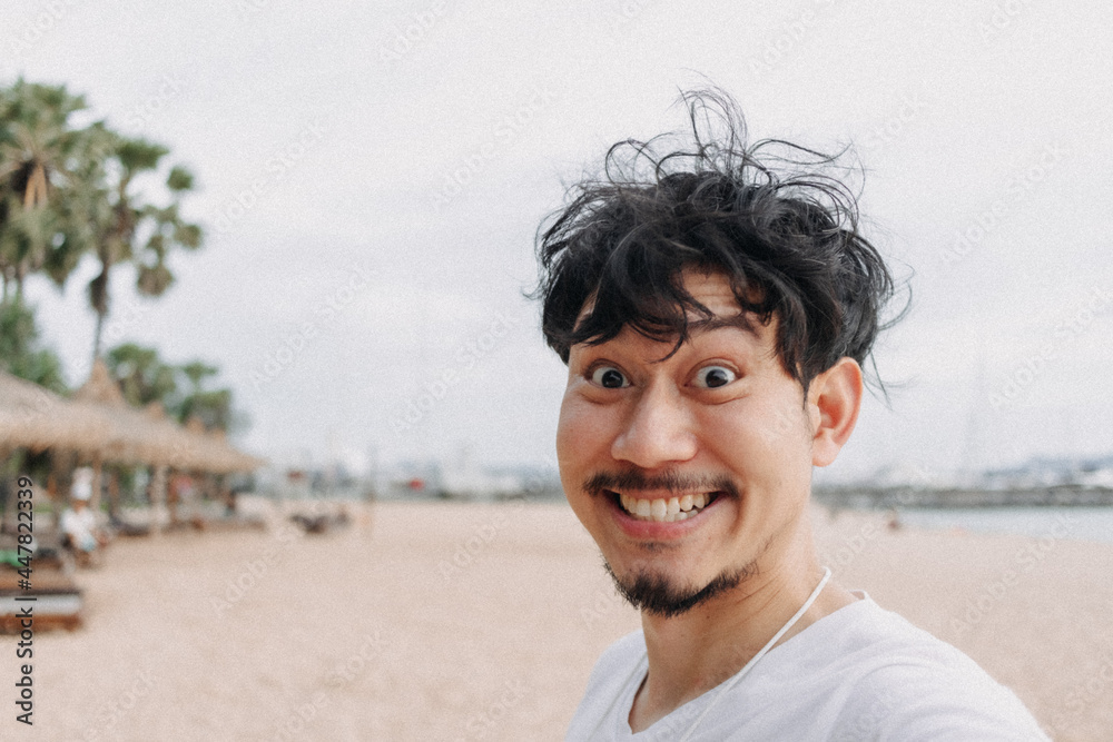Happy Asian man selfie himself relaxed on the beach. Concept of summer holiday. Happy Asian man selfie himself relaxed on the beach. Concept of summer holiday.