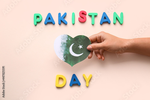 Female hand with flag of Pa...