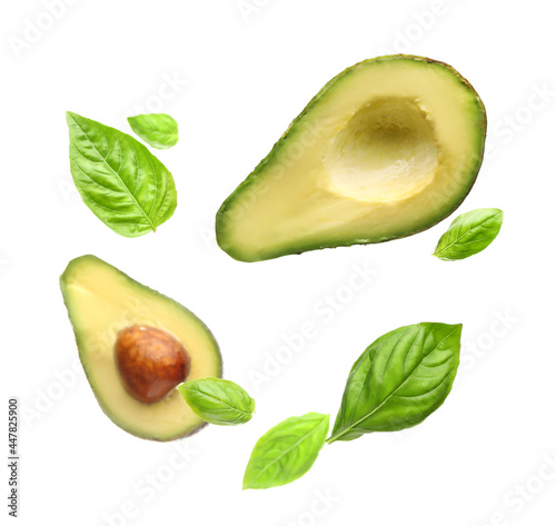 Flying avocado and basil leaves on white background