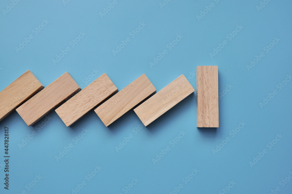 The domino fall is stopped. A symbol of support and stopping the collapse
The domino fall is stopped. A symbol of support and stopping the collapse