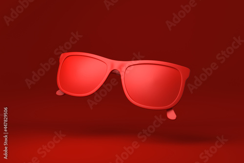 Red Glasses floating in red background. minimal concept idea creative. monochrome. 3D render.