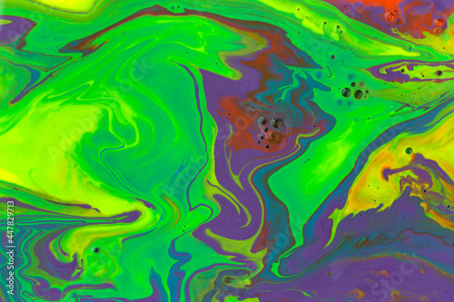 Green and violet marble abstract acrylic background. Vivid artwork texture. Agate ripple pattern.