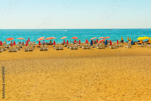 Fototapeta Naklejka Na Ścianę i Meble -  ANTALYA, TURKEY: Sun loungers and umbrellas on the Lara beach on a sunny summer day in Antalya.