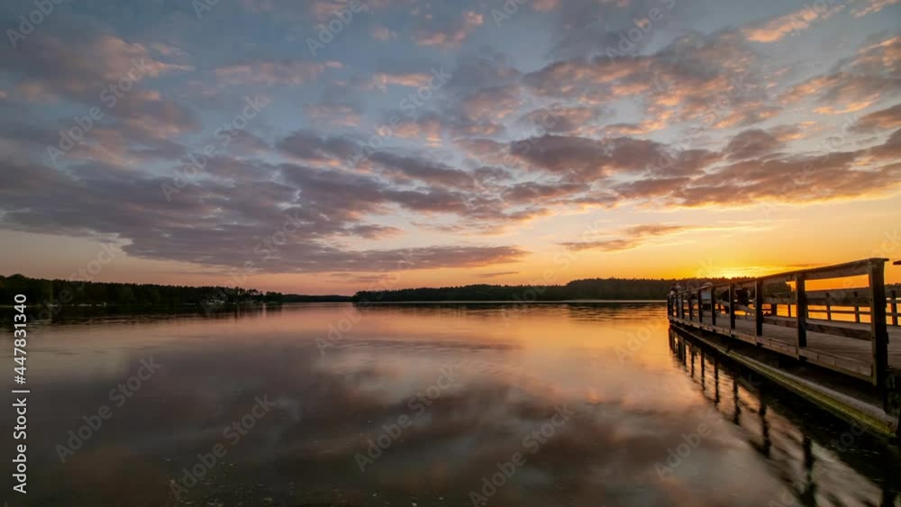 Sunset Sky Over Lake Time Lapse. Clouds Reflecting in Calm Water. Lake Wdzydze, Kashubia,Poland. Sunset Sky Over Lake Time Lapse. Clouds Reflecting in Calm Water. Lake Wdzydze, Kashubia,Poland.