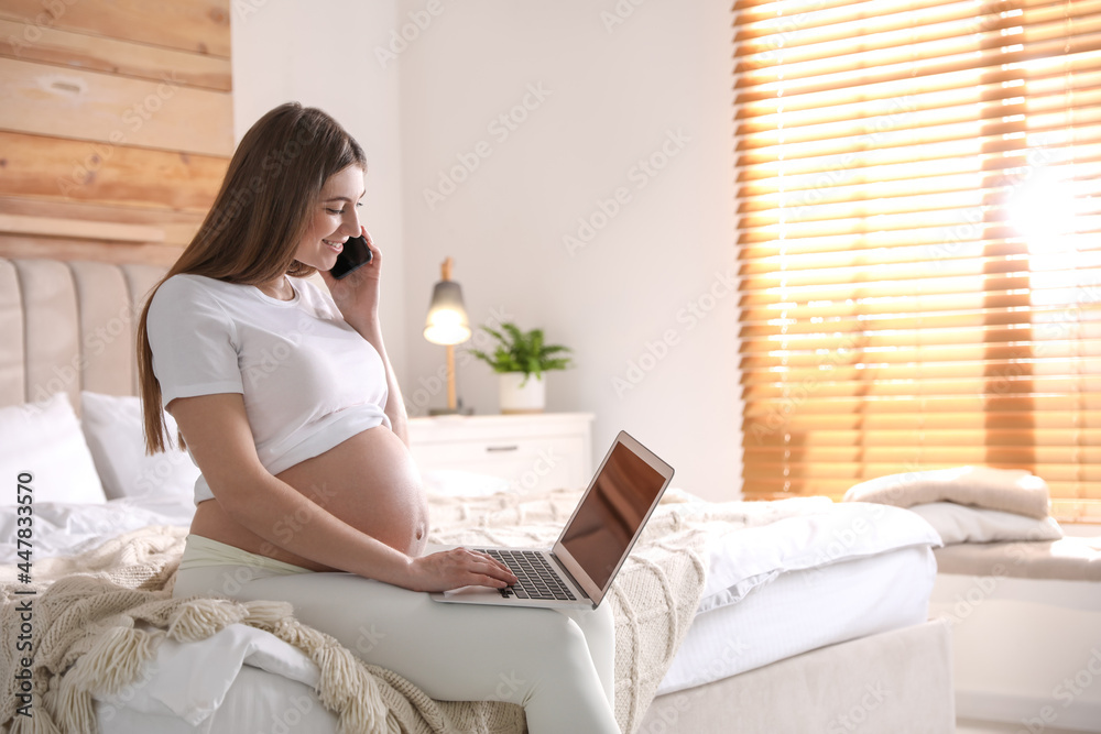 Pregnant woman working on bed at home, space for text. Maternity leave Pregnant woman working on bed at home, space for text. Maternity leave