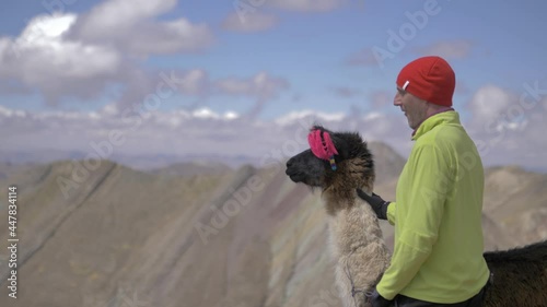 Male model and llama in the new rainbow Mountains of Cusco, Peru at the andes, 7 color mountains photo