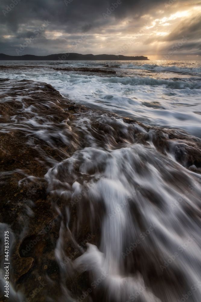 water flowing on the rocks at the beach