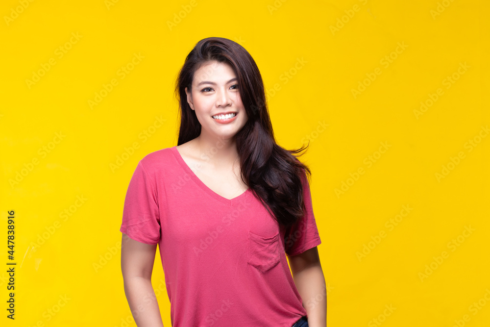 Image of feeling smile and happy. Cheerful young asian woman with brunette long hair in casual shirt smiling with teeth on yellow background. Female face expressions and emotions concept. Image of feeling smile and happy. Cheerful young asian woman with brunette long hair in casual shirt smiling with teeth on yellow background. Female face expressions and emotions concept.