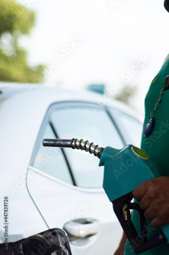 close-up at gas station, attendant refueling vehicle. Selective Focus