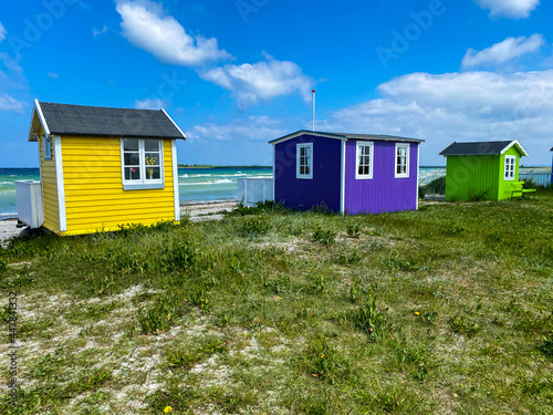Foto Small colorful houses under the sun at the beach on the island of Aero in Denmar
