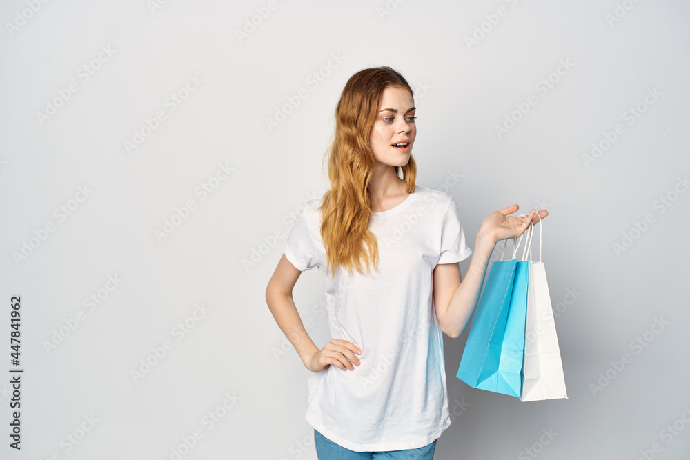 woman with packages in hands shopping entertainment fun light background