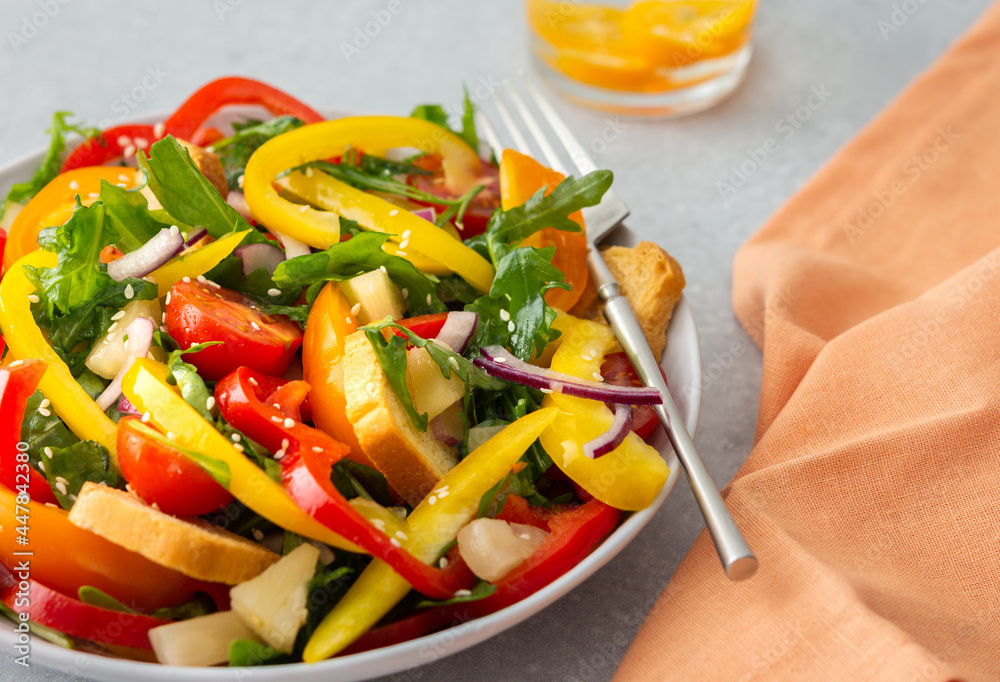 Light summer fresh salad with colorful tomatoes and croutons, sweet peppers and pineapple with sesame seeds, water with kumquats Light summer fresh salad with colorful tomatoes and croutons, sweet peppers and pineapple with sesame seeds, water with kumquats