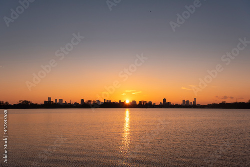 Sunset over the Rotterdam skyline as seen from Kralingse Plas (Lake Kralingen) with colorful sky reflecting © Tjeerd