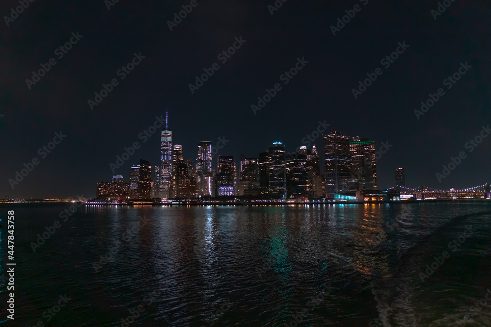 New York city skyline at night viewed from Hudson river