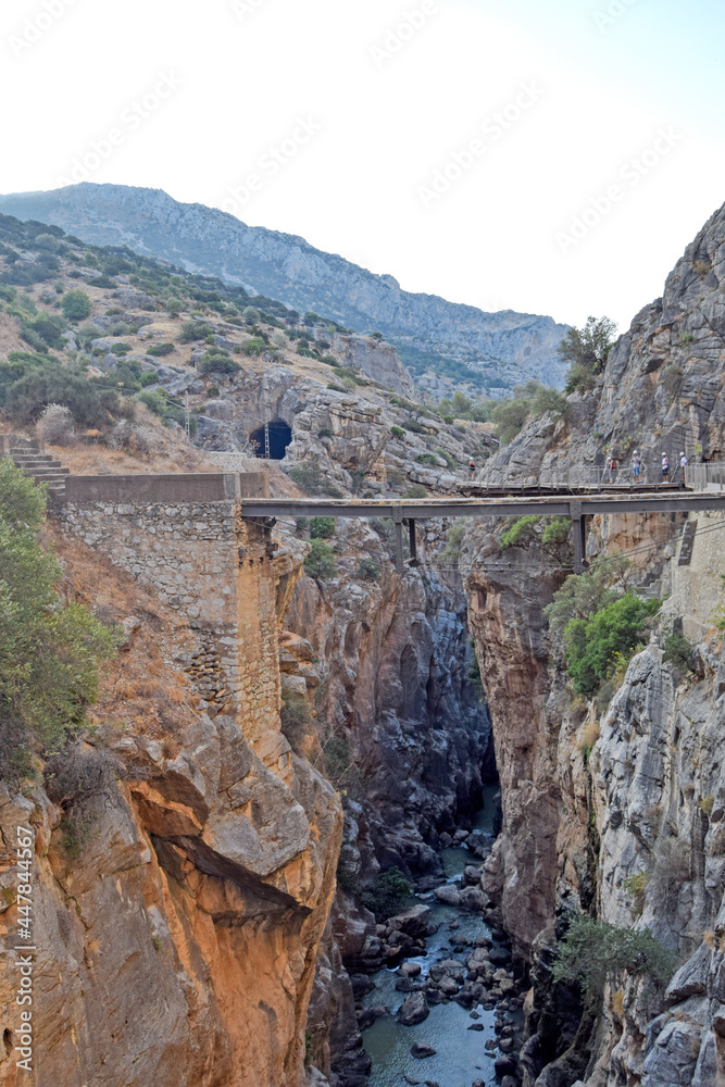 Fototapeta premium Very narrow bridge between two steep mountains of the Caminito del Rey in Desfiladero de los Gaitanes de Sierra de Ardales, Malaga, Andalusia, Spain