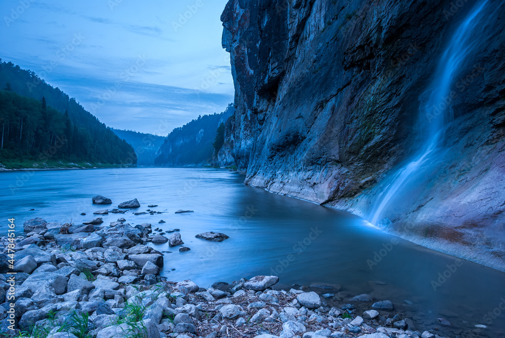 Landscapes of Siberia. Evening landscape at sunset. Mountains, forest, river and water and waterfall at long exposure. Kemerovo region. Russia