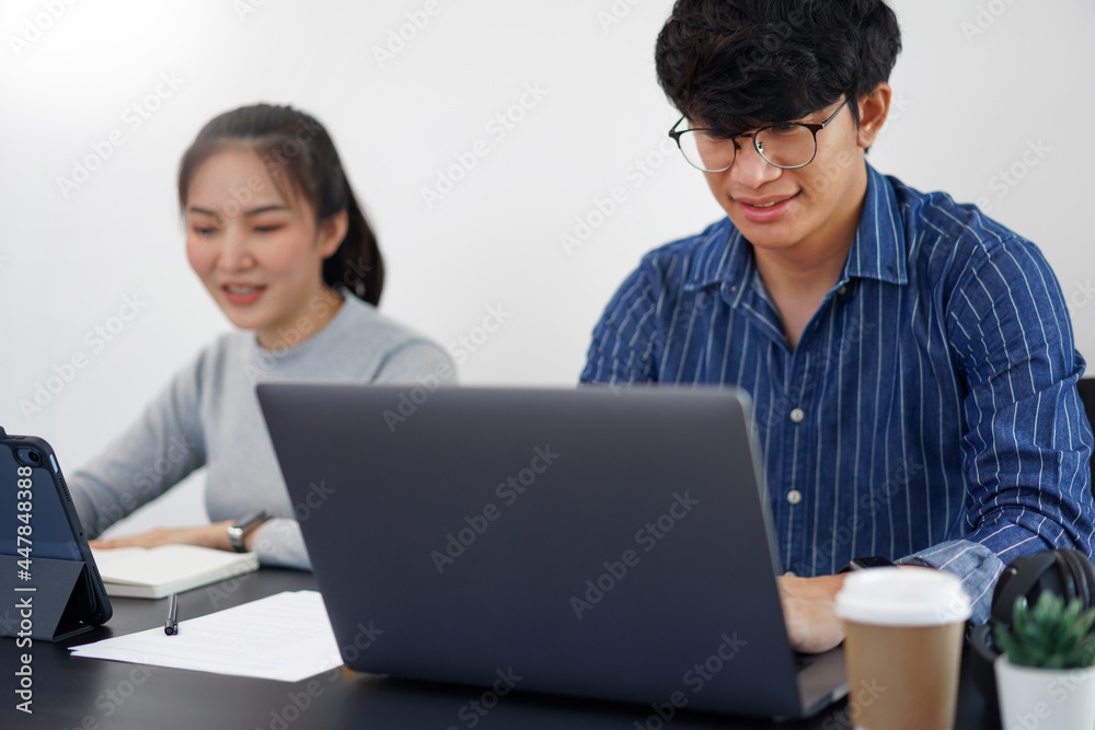 Office work concept two business person working on the devices with two cups of coffee in the office Office work concept two business person working on the devices with two cups of coffee in the office